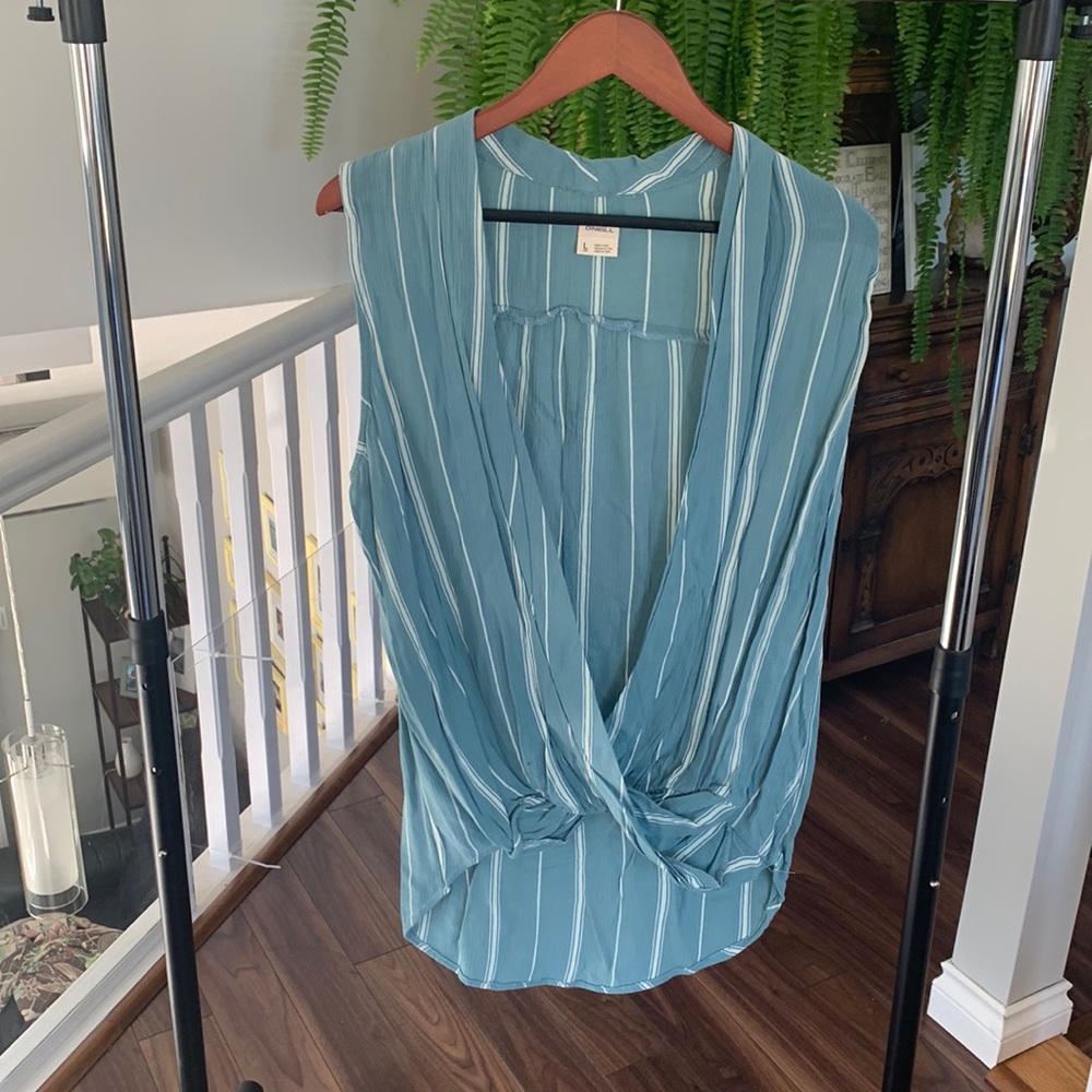 O’Neil shirt. Sleeveless, loose fitting wrap style front.
